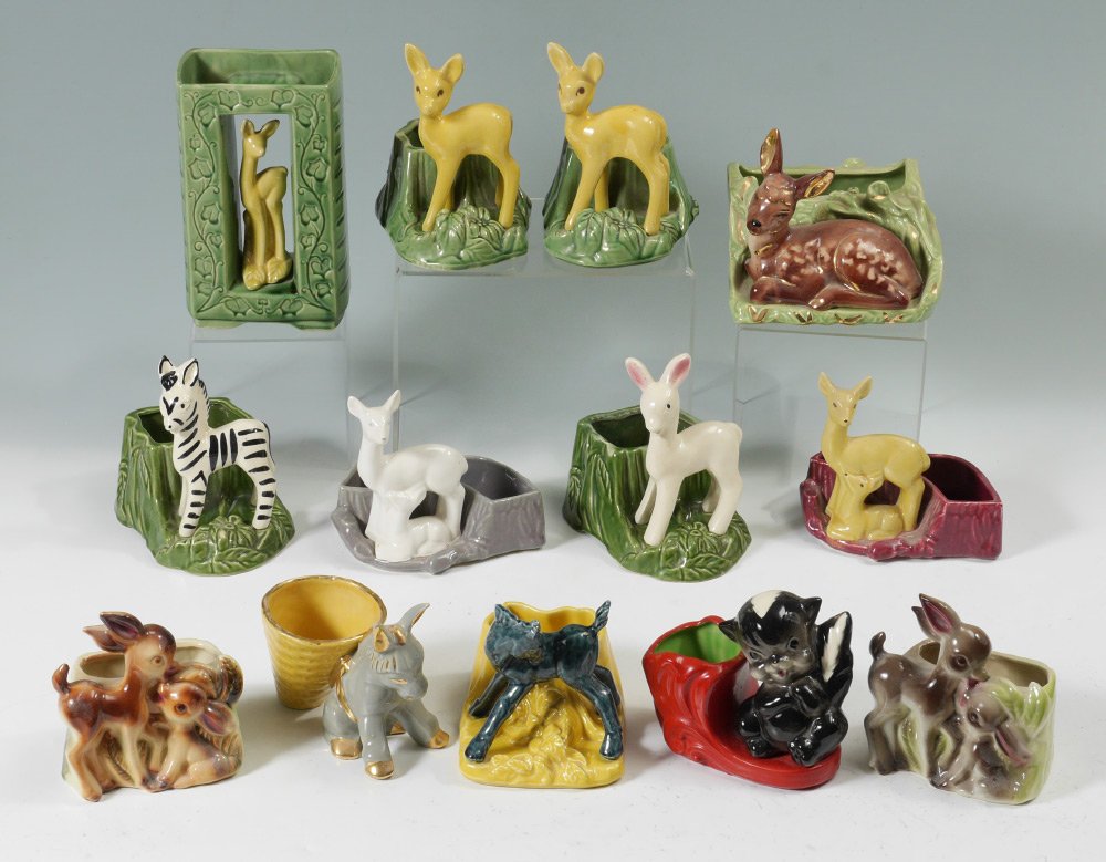 ESTATE SHAWNEE POTTERY COLLECTION DEER PLANTERS: SHAWNEE POTTERY COLLECTION: 10 Deer planters and a Skunk planter marked Shawnee or Kenwood or USA. Doe in a shadowbox measures 8.75" x 5.5" x 3.5", Faun at rest by lot measures 7" x 7" x 7.25". One De