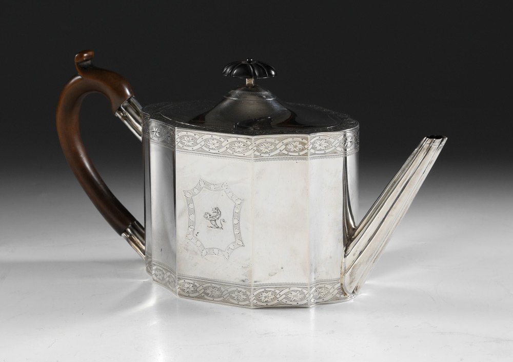 CHARLES STUART HARRIS ENGLISH SILVER TEAPOT: CHARLES STUART HARRIS ENGLISH SILVER TEAPOT: Sterling teapot hallmarked with Charles Stuart Harris, London, 1904 marks. Engraved decoration with heraldic lion holding a seashell. Ebony finial on hinge