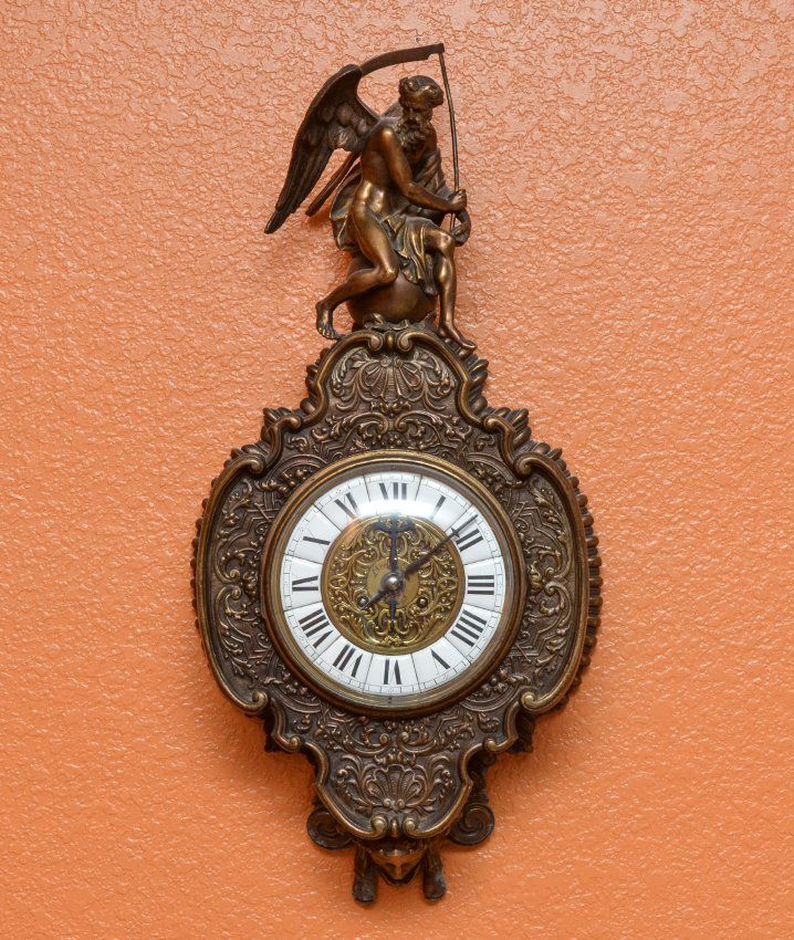LEROLLE FRERES FRENCH FIGURAL REAPER BRONZE CLOCK: LEROLLE FRERES FRENCH FIGURAL REAPER BRONZE WALL CLOCK: Patinated cast bronze case, figure of a winged angel holding a scythe and sitting on sphere final, frame with foliate and shell motifs. Bubble g