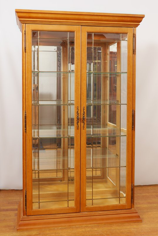 PULASKI FURNITURE ILLUMINATED DISPLAY CABINET: PULASKI FURNITURE ILLUMINATED DISPLAY CABINET: Double doors with leaded glass panels and split glass sides, illuminated mirrored back interior, 4 glass shelves, Pulaski label on back. Overall measures