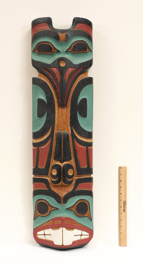 RAY PECK TLINGIT RAVEN BEAVER TOTEM CARVING: PECK, Ray, (Tlingit, 20th Century): Polychrome decorated Northwest Raven Beaver wall totem, carved from red cedar, signed on back. This totem represents the carver's clan, overall measures 34 3/4" h. 