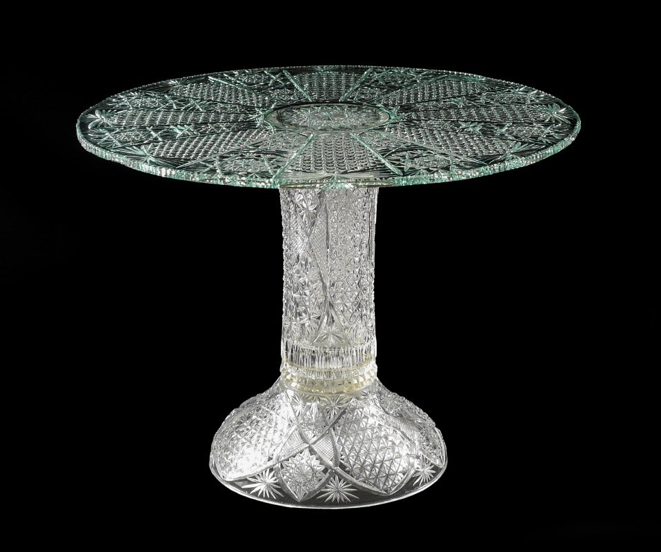 SHOW STOPPING CUT GLASS CAKE STAND: SHOW STOPPING CUT GLASS CAKE STAND: Contemporary cut glass, clear body, top with green tint, no visible markings. Perfect for a wedding or larger cake, overall 17 3/4''h. x 23 1/4''.