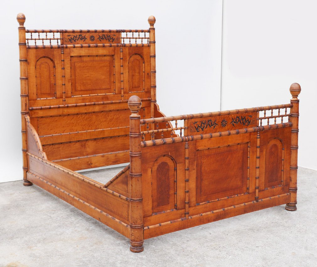 HORNER STYLE VICTORIAN FAUX BAMBOO BED: HORNER STYLE VICTORIAN FAUX BAMBOO BED: Crests with carved bamboo shoots and sun motifs, carved faux bamboo with bird's eye maple veneer panels. Headboard 64 1/2" h. x 63" x 3 1/2", foot board 40 1/4"
