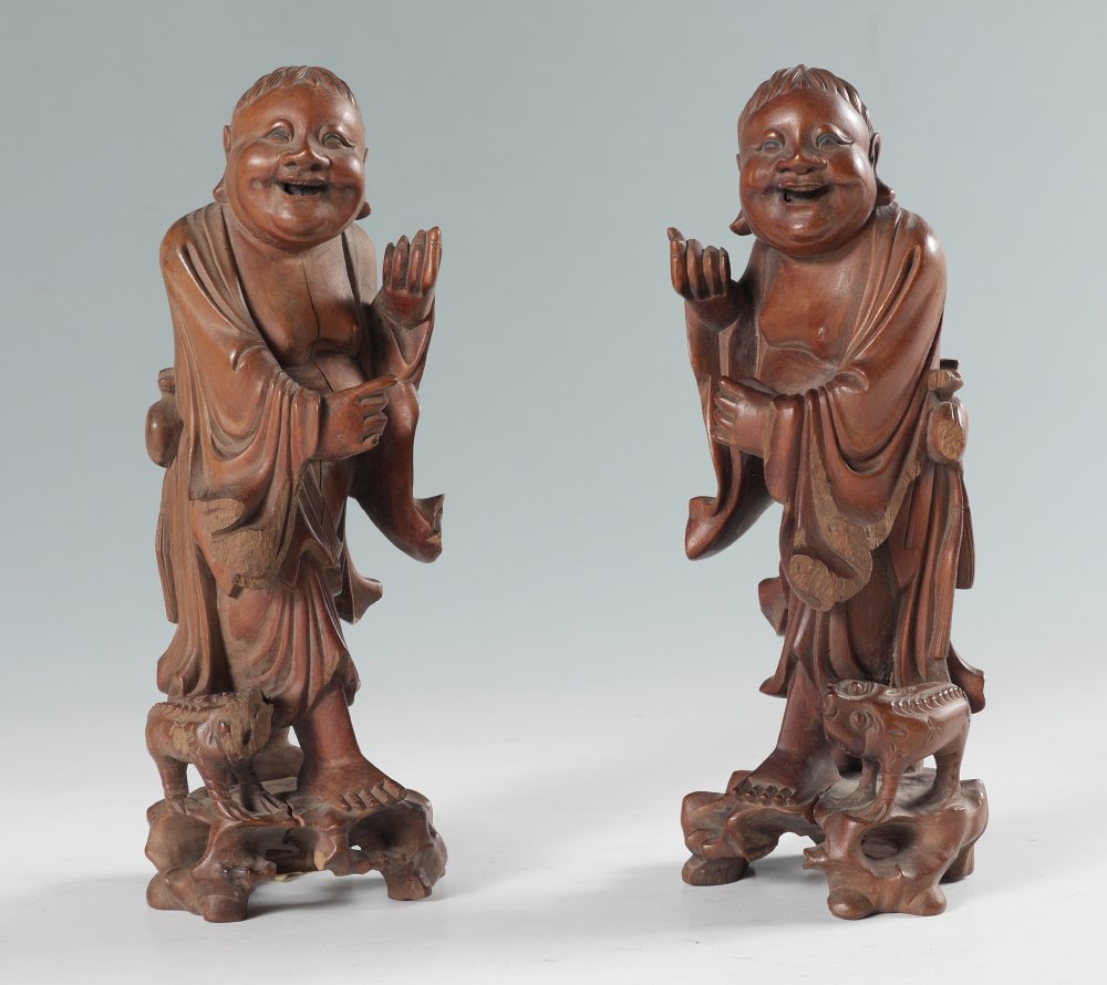 PAIR JAPANESE CARVED WOOD FIGURES: PAIR JAPANESE CARVED WOOD FIGURES: Mirror image pair of smiling men with dog at feet, no visible signature, measures 8 3/4'' h. x 3 1/4'' x 3''.