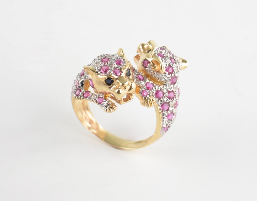 RUBY & DIAMOND LEOPARD BYPASS RING: RUBY & DIAMOND LEOPARD BYPASS RING: 14k yellow gold double figural leopard ring pave set with diamond and ruby pelt and blue sapphire eyes. Total diamond weight is .27 Ct. approx, total sapphire weigh