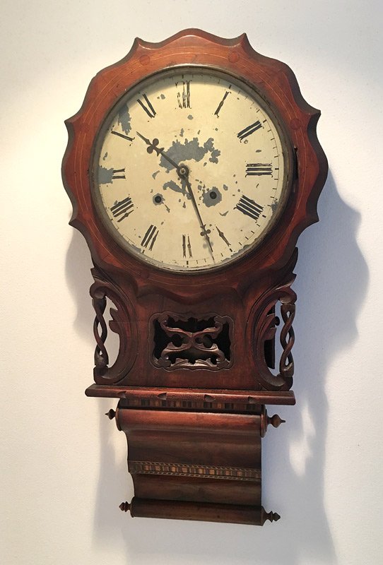 E.N. WELCH CARVED & INLAID WALL CLOCK: E.N. WELCH CARVED & INLAID WALL CLOCK: Shaped wood bezel with string inlay over twist and open work panel, scroll lower finial, with parquetry inlay. Painted metal dial, time and strike movement. Over