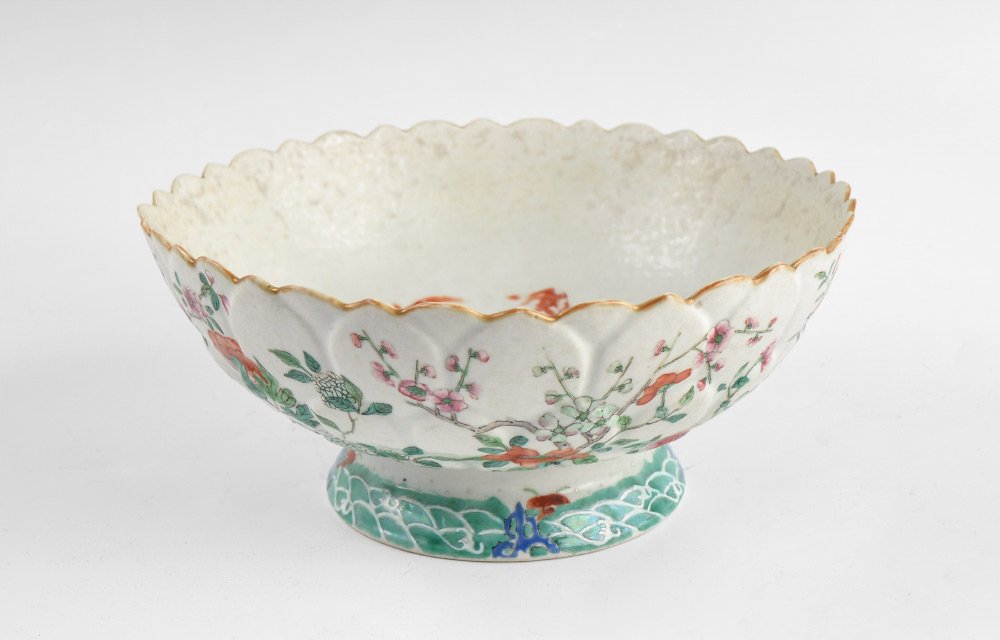 CHINESE FAMILLE ROSE LOTUS FORM BOWL: CHINESE FAMILLE ROSE LOTUS FORM BOWL: Stylized lotus form footed bowl with incised petal sides, gold fish decorated interior, floral motif exterior. No markings, overall measures 4 1/2" h. x 10" dia.