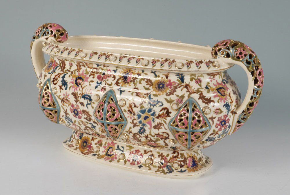 FISCHER BUDAPEST ZSOLNAY RETICULATED CONSOLE BOWL: FISCHER BUDAPEST ZSOLNAY RETICULATED CONSOLE BOWL: Pre 1900 double reticulated pierced handles, cream ground body with polychrome floral decoration and formed reticulated panels, marked on base with b