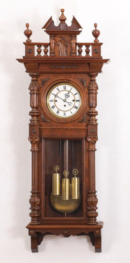 GERMAN WALNUT TRIPLE WEIGHT REGULATOR CLOCK: GERMAN WALNUT TRIPLE WEIGHT REGULATOR CLOCK: Removable architectural pediment with urn finials, door with carved and fluted half columns. Enameled dial with Roman numerals, Gebruder Resch triple weigh
