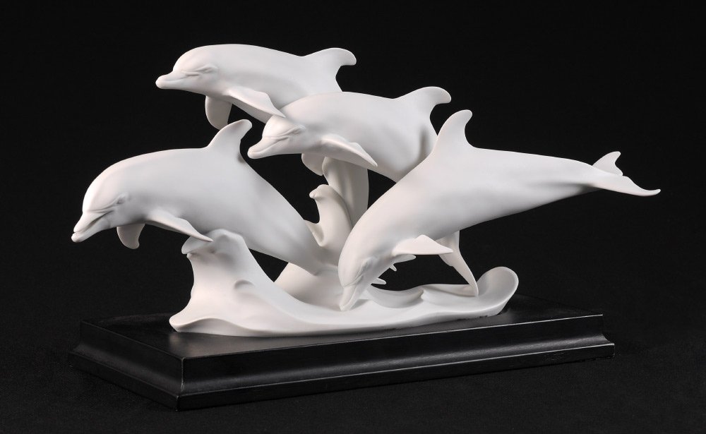 KAISER BISQUE DOLPHIN FIGURAL GROUP: KAISER BISQUE DOLPHIN FIGURAL GROUP: Unpainted bisque grouping of 4 dolphin, limited edition #1238/3000. Well-marked on base, measures 7 3/4" h. x 18 1/2" x 5 1/2". Sold with a fitted wood base, 1 1/4