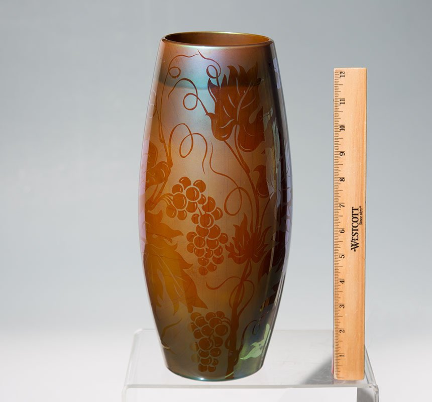 1930'S ZSOLNAY EOSIN GLAZE VASE: 1930'S ZSOLNAY EOSIN GLAZE VASE: Grape vine motif iridescent Eosin glaze finish, marked on base with Zsolnay Pecs, 8764/IV mark. Overall 13'' h. x 6''.