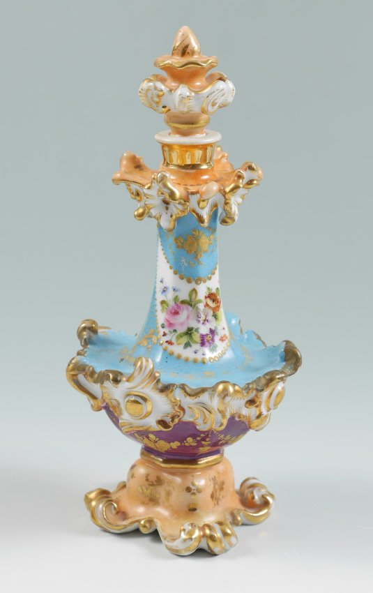 JACOB PETIT HAND PAINTED PORCELAIN PERFUME BOTTLE: JACOB PETIT HAND PAINTED PORCELAIN PERFUME BOTTLE: 19th century, hand painted floral garland in reserves. Jacob Petit blue makers mark on base, overall measures 9 1/4'' h. x 4 1/2''.