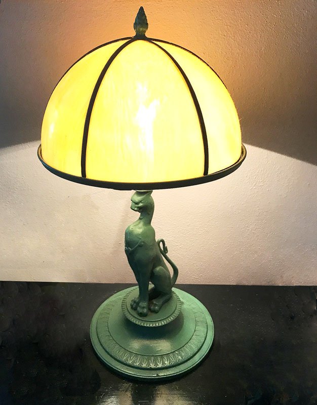 VINTAGE ART DECO ERA SLAG GLASS CAT LAMP: VINTAGE ART DECO ERA SLAG GLASS CAT LAMP: Cast metal base with a full bodied Egyptian motif green cat sitting under a domed caramel slag glass shade. 19" h, 10" dia shade.