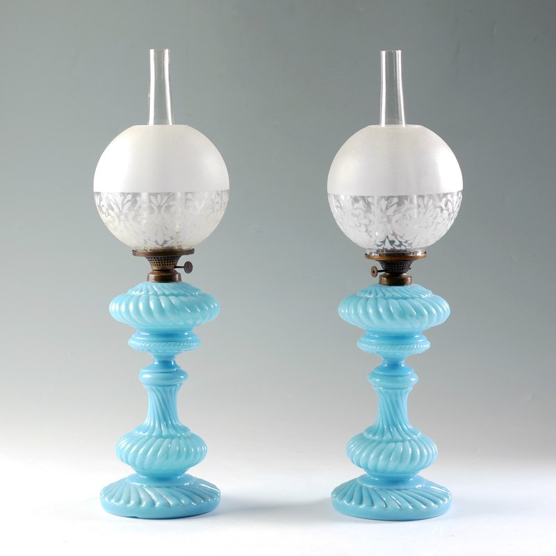 PAIR OF BLUE OPALINE GLASS OIL LAMPS: PAIR OF BLUE OPALINE GLASS OIL LAMPS: Light blue opaline glass bodies, ribbed with alternating twist, 13 1/4" h. x 5 1/2". Sold with frosted glass globe shade, 6" dia., and clear chimneys, 9 1/2" h.