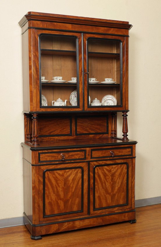 FRENCH MAHOGANY BOOKCASE CUPBOARD: FRENCH MAHOGANY BOOKCASE CUPBOARD: Stepped pediment, top with 2 glass doors, 2 internal wood shelves, fluted turned supports. Base with 2 drawers over 2 doors. Ebonized wood trim accents. Overall meas