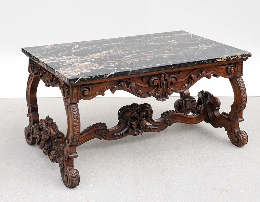 PROFUSELY CARVED MARBLE TOP COFFEE TABLE: PROFUSELY CARVED MARBLE TOP COFFEE TABLE: Base carved all over in the rococo style with foliate scroll motifs. 21 1/2" h. x 42" x 26". Sold with a restored marble top, 42 3/4" x 26 3/4" x 1".