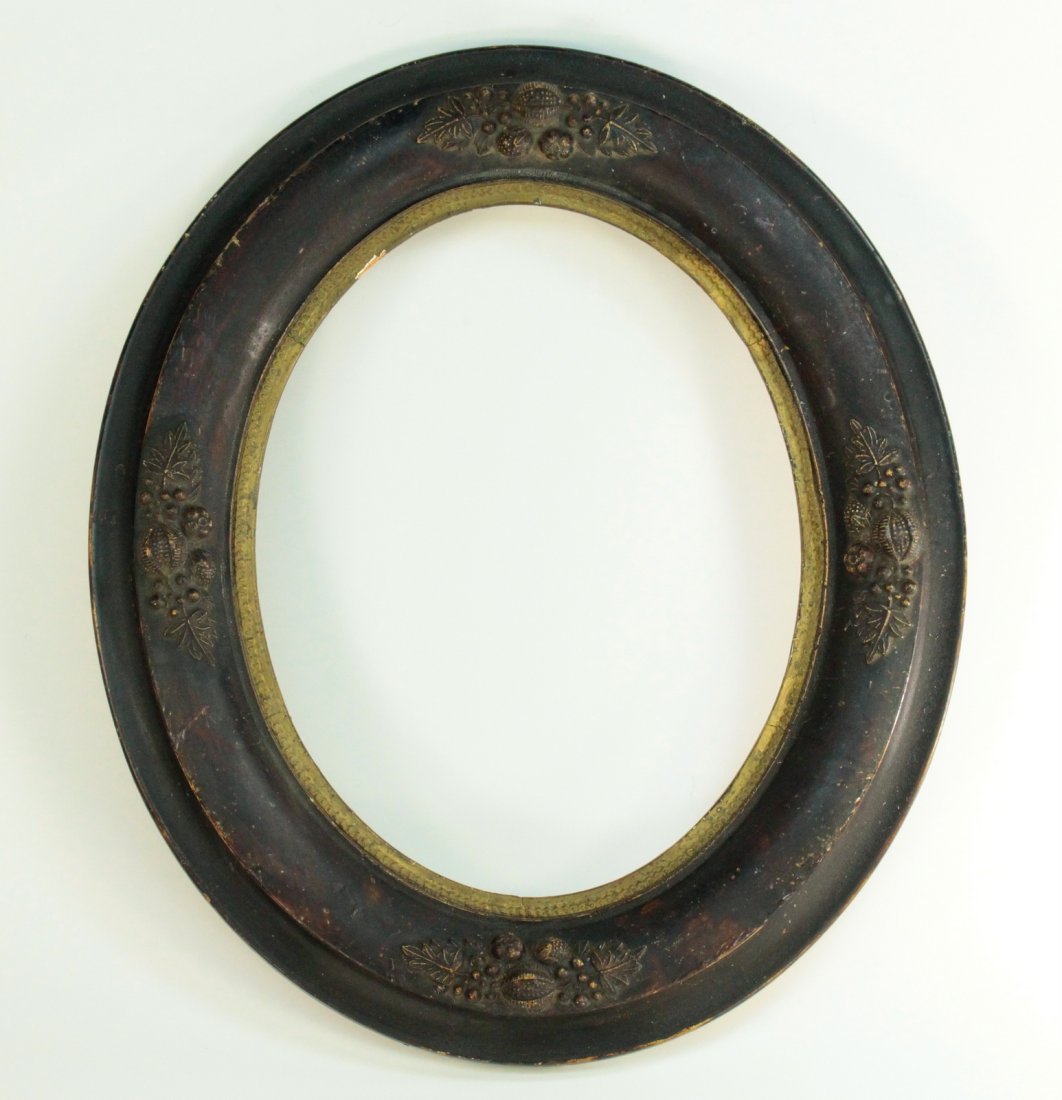 Antique 1800 Victorian Oval Frame Ebonized Wood: Antique Victorian oval frame,characteristic for the period shape and ornamentation, black ebonized finish on gesso over wood base, fruit themed molded decorations on 4 sides, brass colored inner edge.