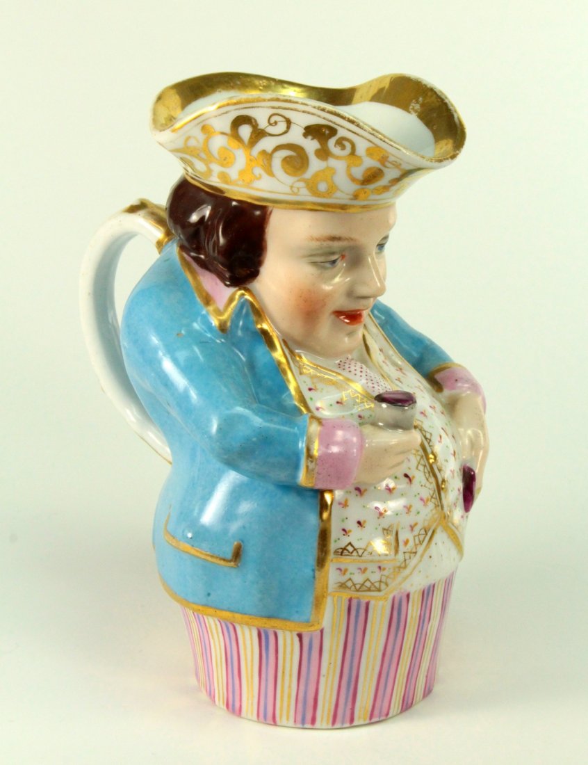 Staffordshire Fillpot Toby Face Jug Sherry Wine Drinker: Antique Toby Jug, made of fine white porcelain. Displays a seated and jovial heavy-set man, holding a small rummer of Sherry wine. His Tricorn cap hat forms the spout. All expertly hand painted with b