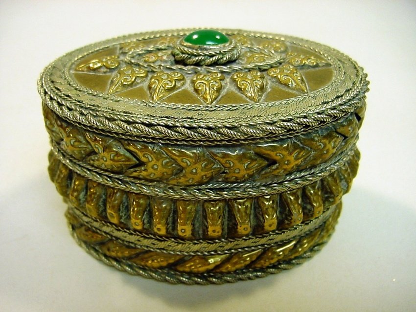 Indo-British Tooled Brass Tabatiere, Green Stone: Hand hammered brass with silver ornamentation. Most likely low-grade silver. Green stone up top, well inlaid. Indo-British from the Raj period. Circa early 1900's. Measurements: Approx 3" x 4.25" x 2.