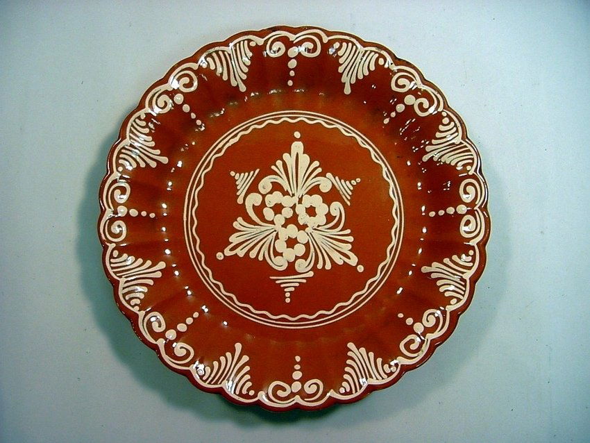 Antique Redware Slipware Glazed Wall Charger 11+": Thick red earthenware. White Slip decoration and Heavy Glaze. Circa late 1800's. Measurements: Approx. 11.25" diameter