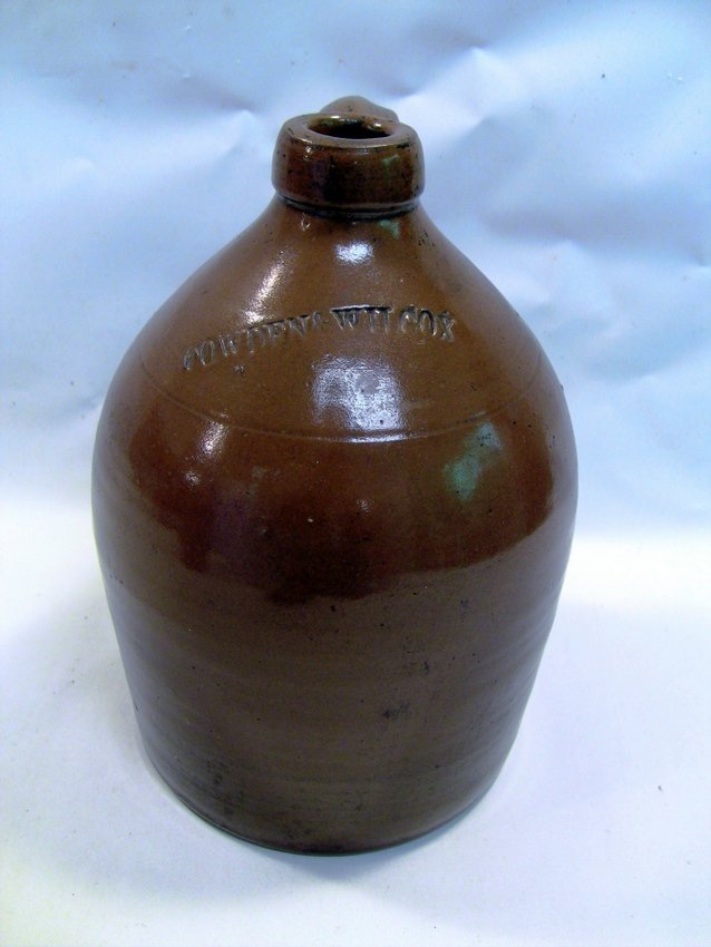 c.1863 COWDEN & WILCOX Ovoid Redware Crock Jug: Crock jug. Thick redware pottery. Heavy tin glaze. Stamped up front - Cowden & Wilcox. Antique stoneware made by John Cowden & Isaac Wilcox is often regarded as some of the most desired American potte