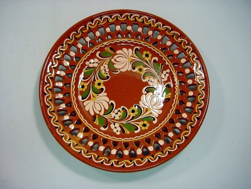 Glazed Redware Slipware Pierced Wall Plate: Glazed redware, masterful polychrome slipware decorations. Reticulated border edge. Signed on the back "MHU 9". Measurements: Approx. 12" diameter
