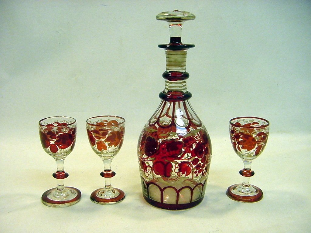 1850s Ruby to Clear Bohemian Decanter & 3 Goblets: All hand blown, etched and decorated Ruby to Clear glass. A decanter with its original stopper and 3 small dessert wine/liquor goblets. Bohemian from the mid to third quarter of the 19th Century. All 