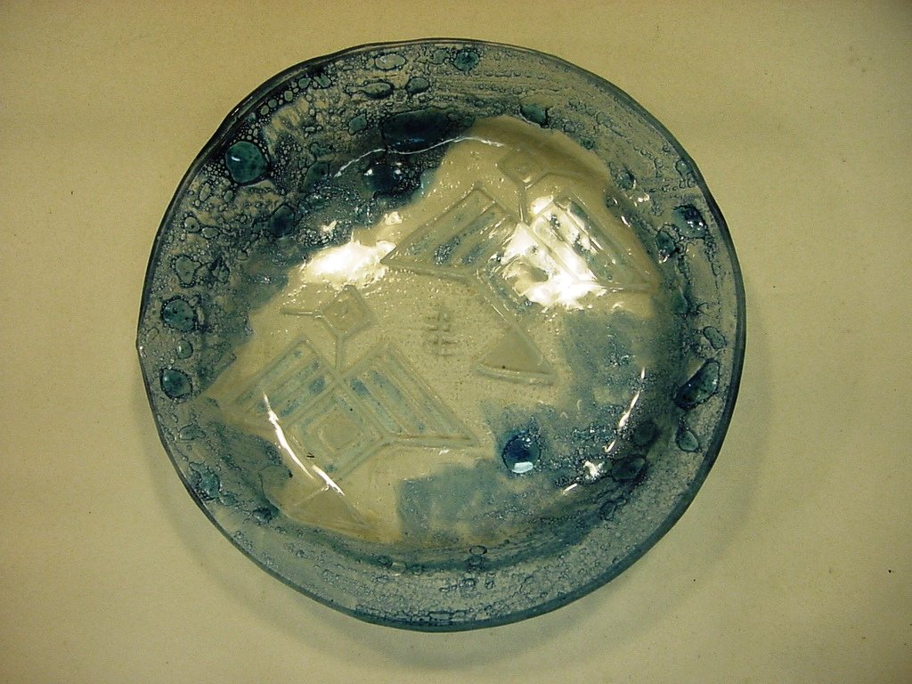Blown Navajo Native American Art Glass Plate: A very unusual and expertly made hand blown blue glass plate or shallow bowl. Native American, likely Navajo motifs of flying mythical birds. Artist's initialed in the centrum. Measurements: Approx. 5