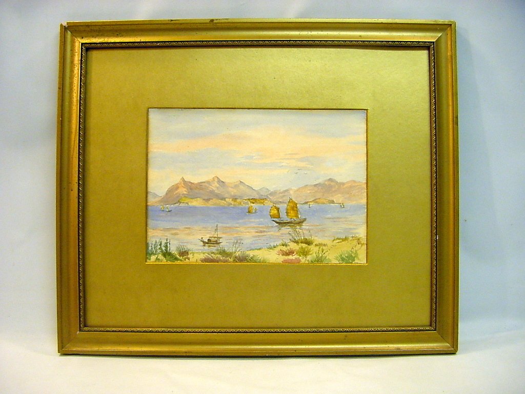 British School 19-20th C Watercolor, Hong Kong: A well executed watercolor, depicting a seaside scene around Hong Kong with Junk Boats amidst a picturesque background. Signed lower right - FWB, or so. Inscribed on the back by the artist with the ti
