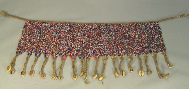 c.1900 W.African Skirt KIRDI Cameroon Beadwork & Shells: Traditional ceremonial Apron or Skirt. All handcrafted. Intricate colorful glass beads. Decorated with hanging Cowry seashells. Authentic antqiue African Tribal Artifact. West Africa, Cameroon (Kamero