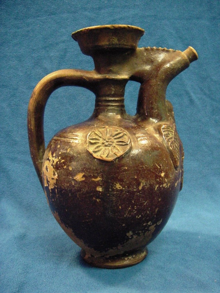 1800s Brown Ottoman Turkish Vinegar Jug 8.5”: Ethnic vessel used for storing vinegar. Thick eathernware ceramic, heavily glazed with dark brown glaze. Characteristic shape and design. Rosette medallions and floral patterned ornamentation. Separat