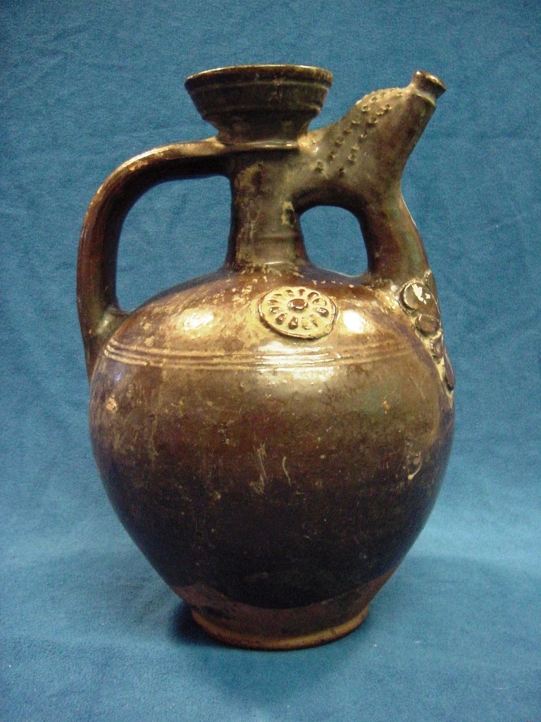 1800s Brown Glaze Ottoman Turkish Vinegar Jug: Ethnic vessel used for storing vinegar. Thick eathernware ceramic, heavily glazed with dark brown glaze. Characteristic shape and design. Rosette medallions and floral patterned ornamentation. Separat