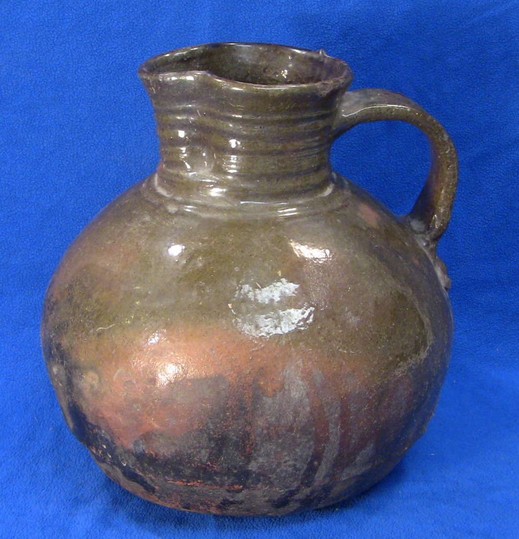 18/19th C. Glazed Earthenware Ethnic Vessel Pitcher: Late colonial. Large cooking vessel, most likely a jug or pitcher. Potted out of redware or a reddish local earthenware. The bottom is left unglazed. Made all by hand, without using a pottery wheel. V