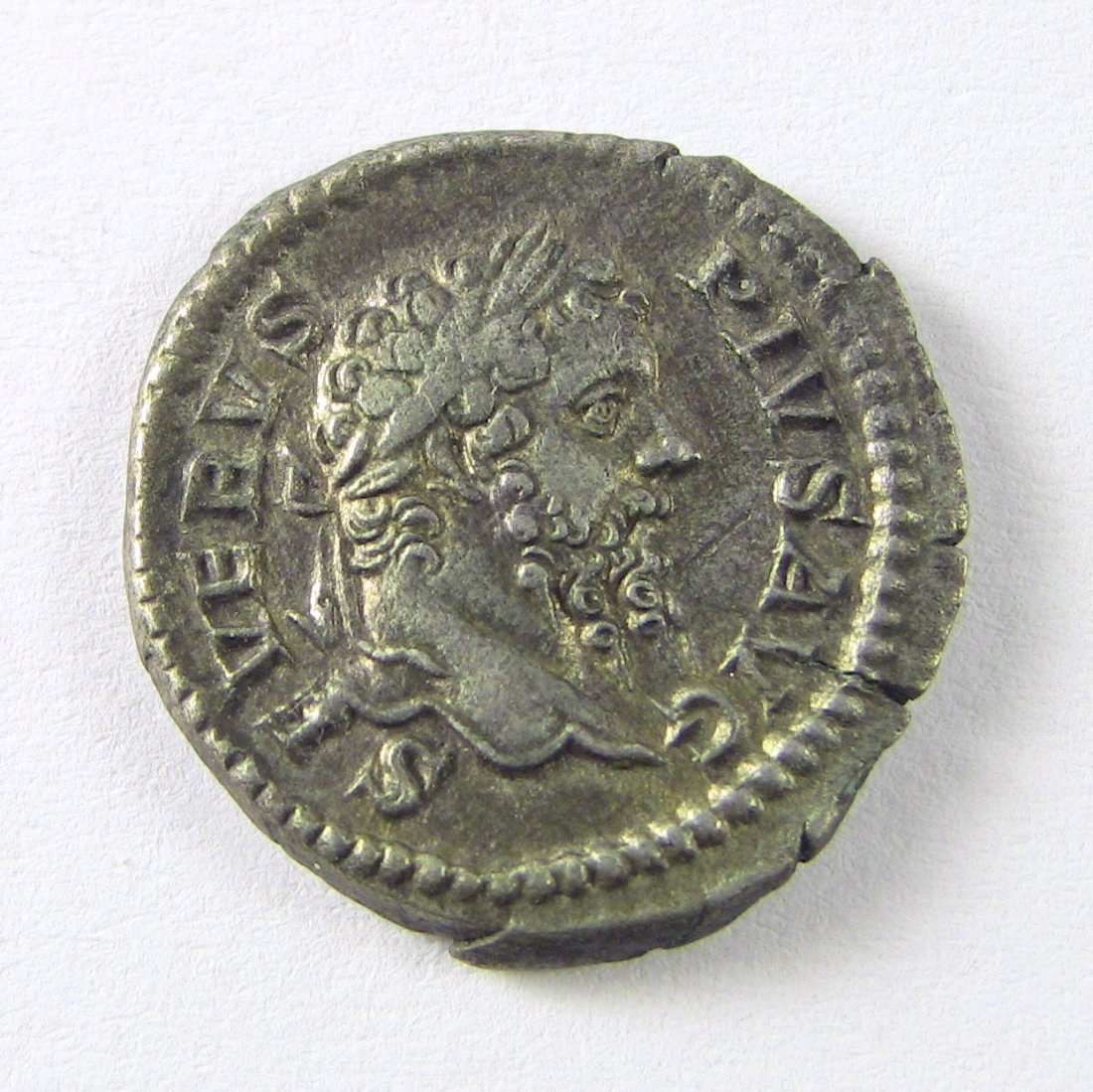 193-211 AD SEPTIMIUS SEVERUS Silver AR Denarius: Roman Denarius, struck 193-211 AD. Avers: Laureate Bust of Septimius Severus, facing right. Reverse: The Emperor, represented as Jupiter w. Caracalla & Geta at feet. Measurements: Approx. 20 mm x 19 m