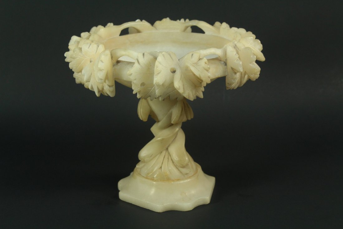 1800's Carved White Alabaster Compote Raised Bowl: Compote or raised bowl. Thick hand carved Alabaster. Deep details. Grape vine motif decoration. Spiraled column and triangular base. Antique piece, dates back to the late 1800's/early 1900's, possibly
