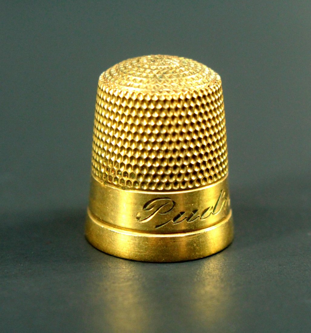 Antique 10K Solid Gold Sewing Thimble: Solid 10-Karat Gold. Sewing thimble. Finely engraved with the name PUDIN in fancy script, up front. A "9" stamped on the back. Marked with an "S" in a Shield Mark and 10K on the inside. Circa 1800's/e