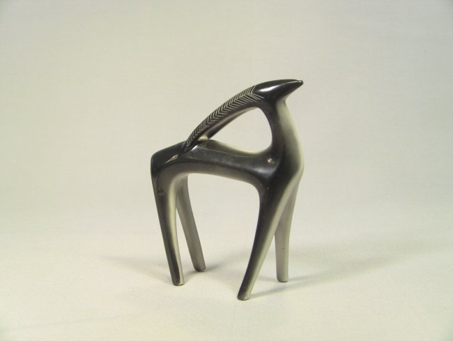 ART DECO Fine Porcelain Figure of an Impala: Fine porcelain. Shaded black/gray over white. Done in a characteristic period manner. Displays a standing Impala or antelope animal with minimalist detail and strong leading lines. Circa 1920-40's, pe