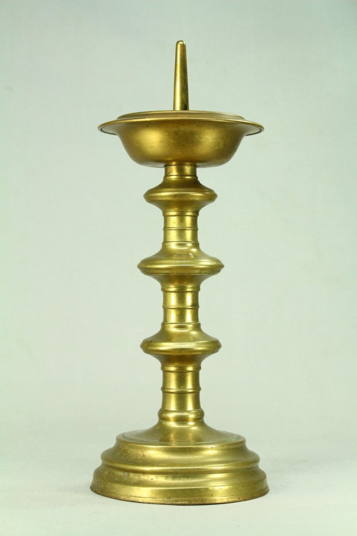1600's Turned/Cast Bronze Pricket Candle Holder: Early antique thick bronze pricket candle holder. Turned bronze body and cast bronze base. Iron support inside, reinforced sometime in the 20th century with a nut bolt. Continental European. Circa 160