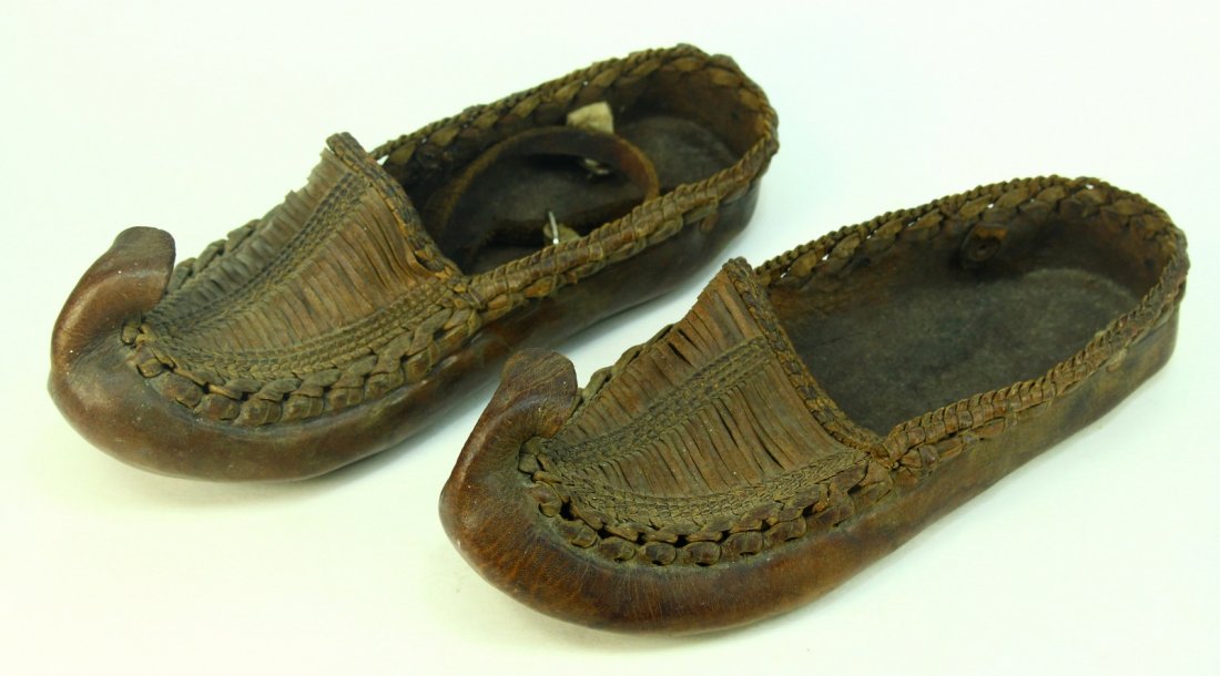 19th c. Pair of Islamic Leather Sandal Moccasin Shoes: Early pair of Islamic footwear. Moccasin or sandal-type shoes. Thick hide leather. Curved, pointed tips. Stitched, braided design. Once had leather straps to secure them to the upper parts of the ankl