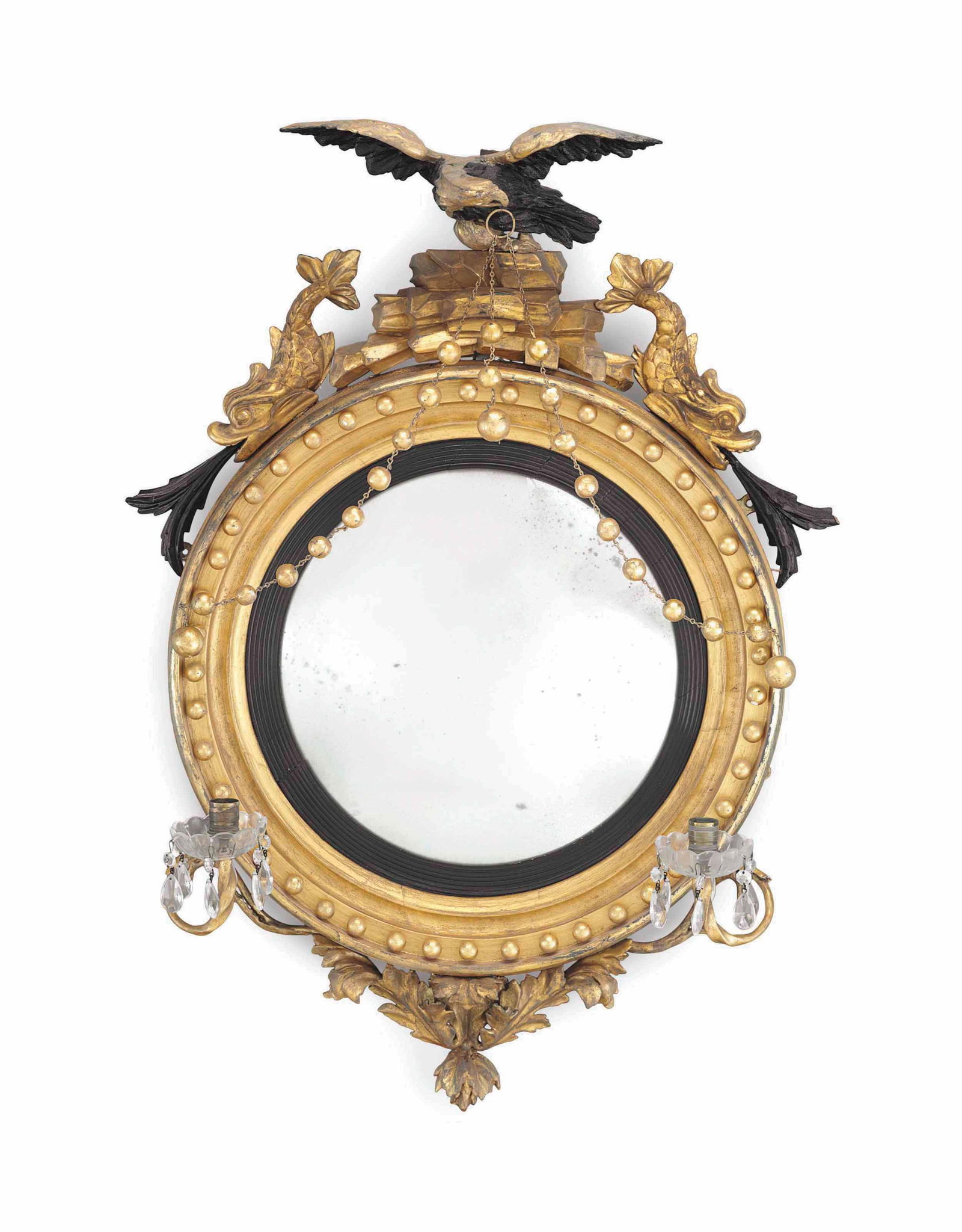 A Classical part-ebonized giltwood two-light Girandole Mirror with an American Gold Eagle adorning: English or American, c. 1815-1825. A Classical part-ebonized giltwood two-light Girandole Mirror. 36 1/2" high, 23" diameter. Provenance: Christie's, 2015 - Property from the Collection of Ted and Ing