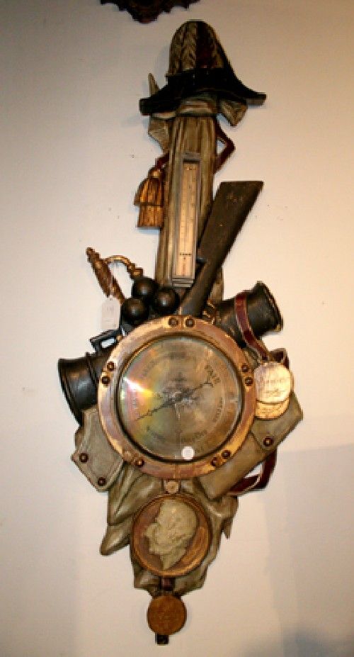 A German Barometer,: A German Barometer, together with an electrified mantle clock, a painted porcelain lamp and a floor lamp. Property from Mr. and Mrs. George and Prudence Miller.