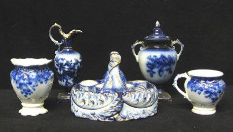 Five piece assorted flow blue group, , Including a: Five piece assorted flow blue group Including a Clayton" pattern vase and cup. H of vase: 5 in. a pitcher shape bud vase, a small covered urn and an embosses and gilt decorated egg basket with 2 cups