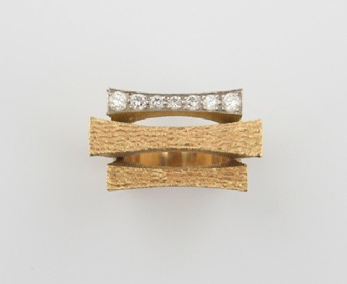 An 18 Karat Yellow Gold and Diamond Ring, Andrew G: An 18 Karat Yellow Gold and Diamond Ring, Andrew Grima, containing seven round brilliant cut diamonds weighing approximately 0.28 carat total, stamp: GRIMA, 0.750, English hallmark. 9.80 dwts.