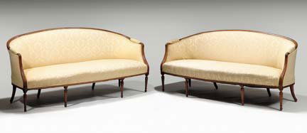 Pair of Louis XVI style walnut settees, early 20t: Pair of Louis XVI style walnut settees early 20th century Each with yellow foliate upholstery, the shaped backs with downswept padded arms above overstuffed seats, raised on turned, tapered and fluted
