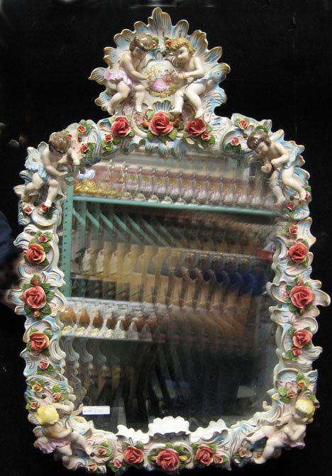 Meissen-style porcelain wall mirror, 20th c., Wit: Meissen-style porcelain wall mirror 20th c. With hand painted and gilt decorated flowers and cherubs H: 30 x W: 20 1/2. PROVENANCE: From the collection of Marie Evans, Alexandria, Virginia