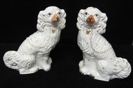 Pair of Staffordshire spaniels, 19th c., Each mod: Pair of Staffordshire spaniels 19th c. Each modeled with gilt collar and chain and painted details. H: 13 in. PROVENANCE: From the collection of Marie Evans, Alexandria, Virginia