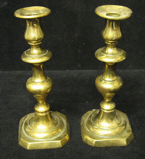 Pair of brass push up candlesticks, 19th c., Ring: Pair of brass push up candlesticks 19th c. Ring turned shaft on square base, lacquered. H: 10 1/4 in. PROVENANCE: From the collection of Marie Evans, Alexandria, Virginia