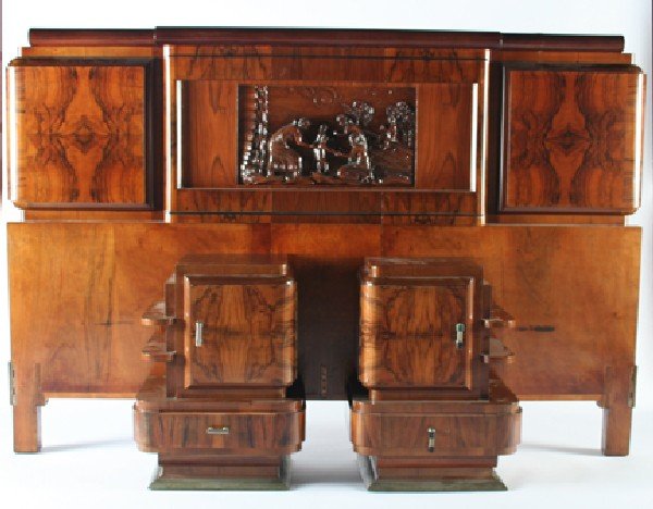 An Italian Art Deco Burled Walnut Five Piece Bedro: An Italian Art Deco Burled Walnut Five Piece Bedroom Suite, comprising a king size bed carved with a figural scene on the headboard and a boy and a girl on the footboard, an armoire having two doors f