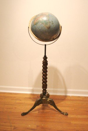 A Library Globe on Stand, Diameter of globe 12 in: A Library Globe on Stand, second half 20th century, the relief globe raised on a metal and turned wood base. Diameter of globe 12 inches.