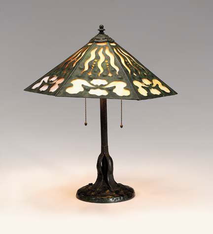 Art Nouveau hammered copper lamp, apollo studios,: Art Nouveau hammered copper lamp apollo studios, early 20th century The faceted hammered shade with stylized cutouts and lined internally with yellow to white opaque glass, raised on a square columnar